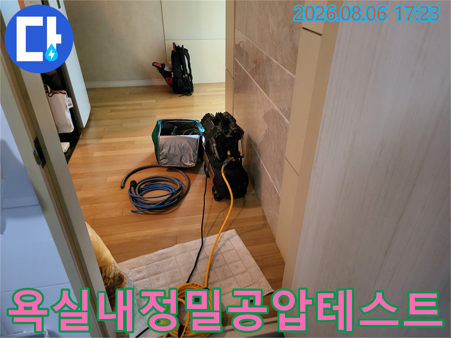 노란색과 파란색 호스가 연결된 욕실 배관 압력 점검 장비 모습
