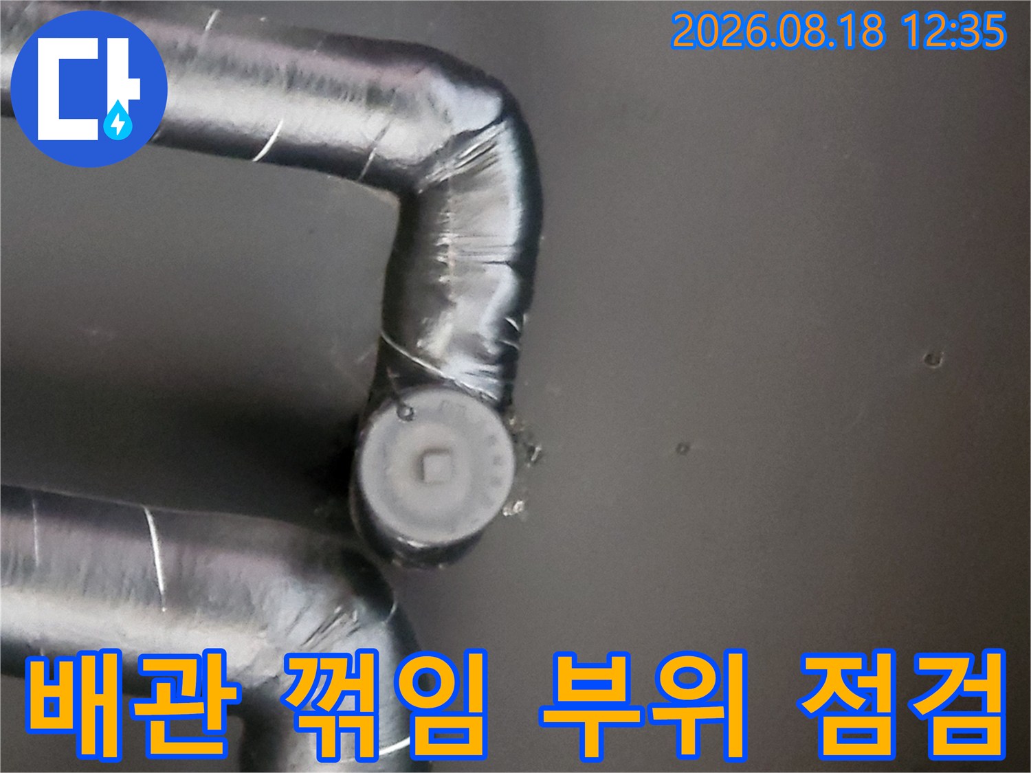 검은색 배관 보온재가 감싸진 굴곡진 연결 부위