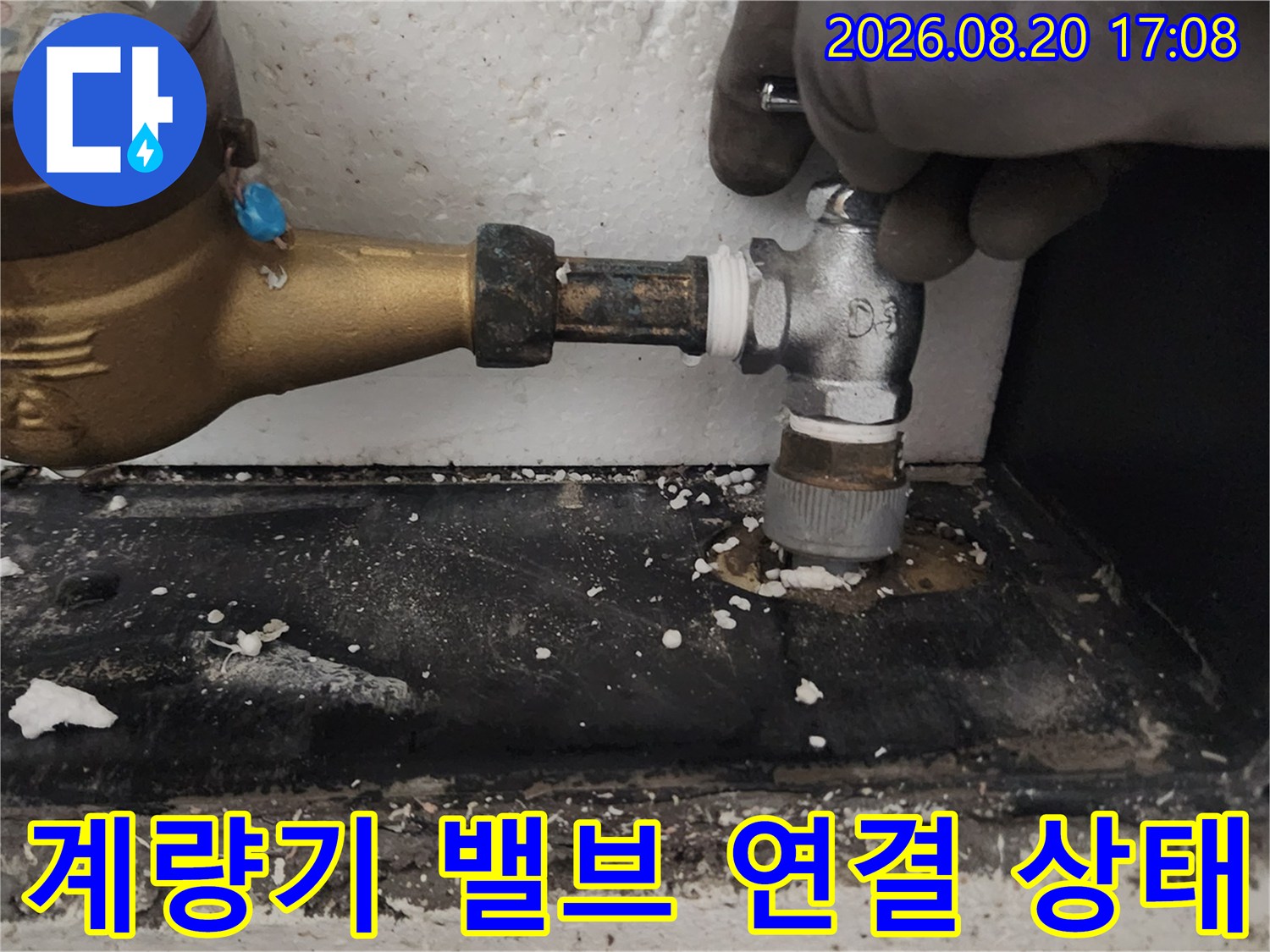 수도 계량기와-연결된 금속 밸브의 누수 여부 확인 중