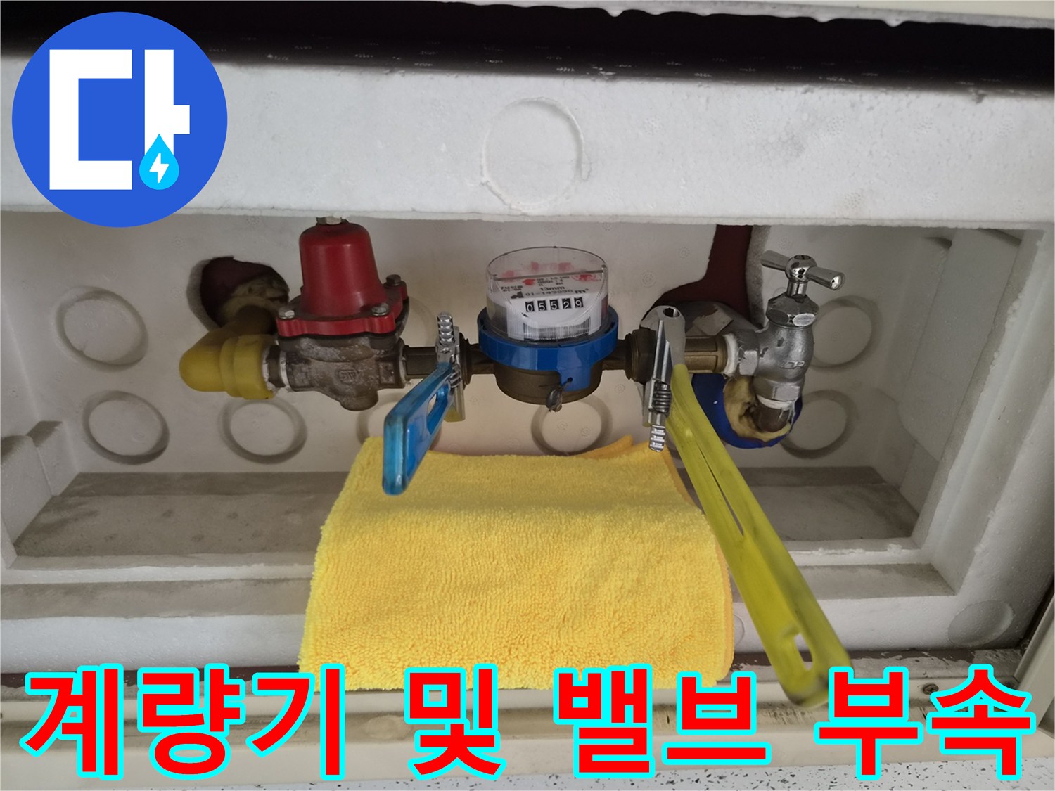 배관 연결 지점과 수도 계량기가 보이는 내부 모습입니다.
