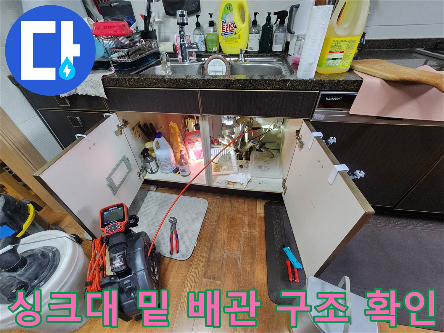 하부장 내부의 복잡한 배관 연결 부위와 누수 지점 관찰