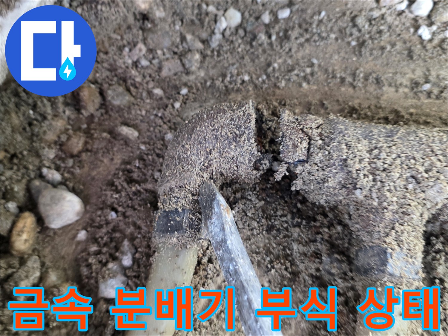 흙과 자갈 사이에 노출된 낡은 금식 분배기 배관