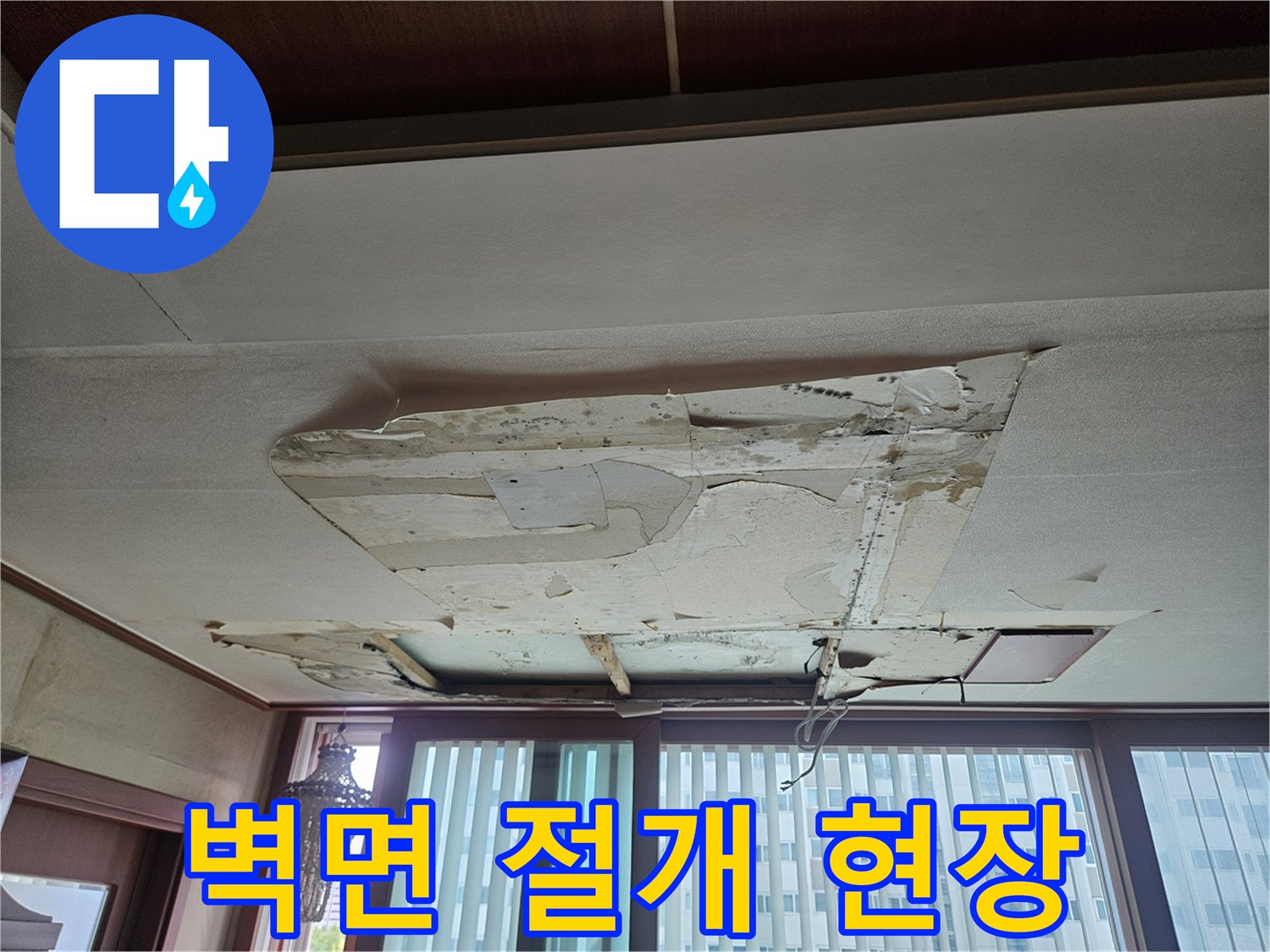 아파트 거실 벽면의 누수로 인해 벽지가 들뜨고 훼손된 모습입니다.