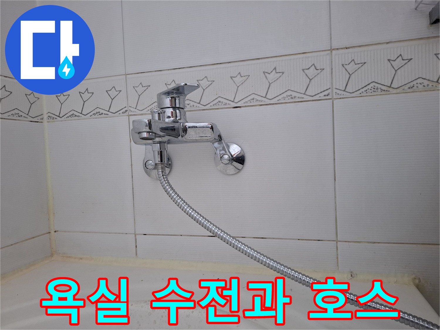 타일 벽면에 부착된 은색 수전 및 샤워 호스 연결 상태