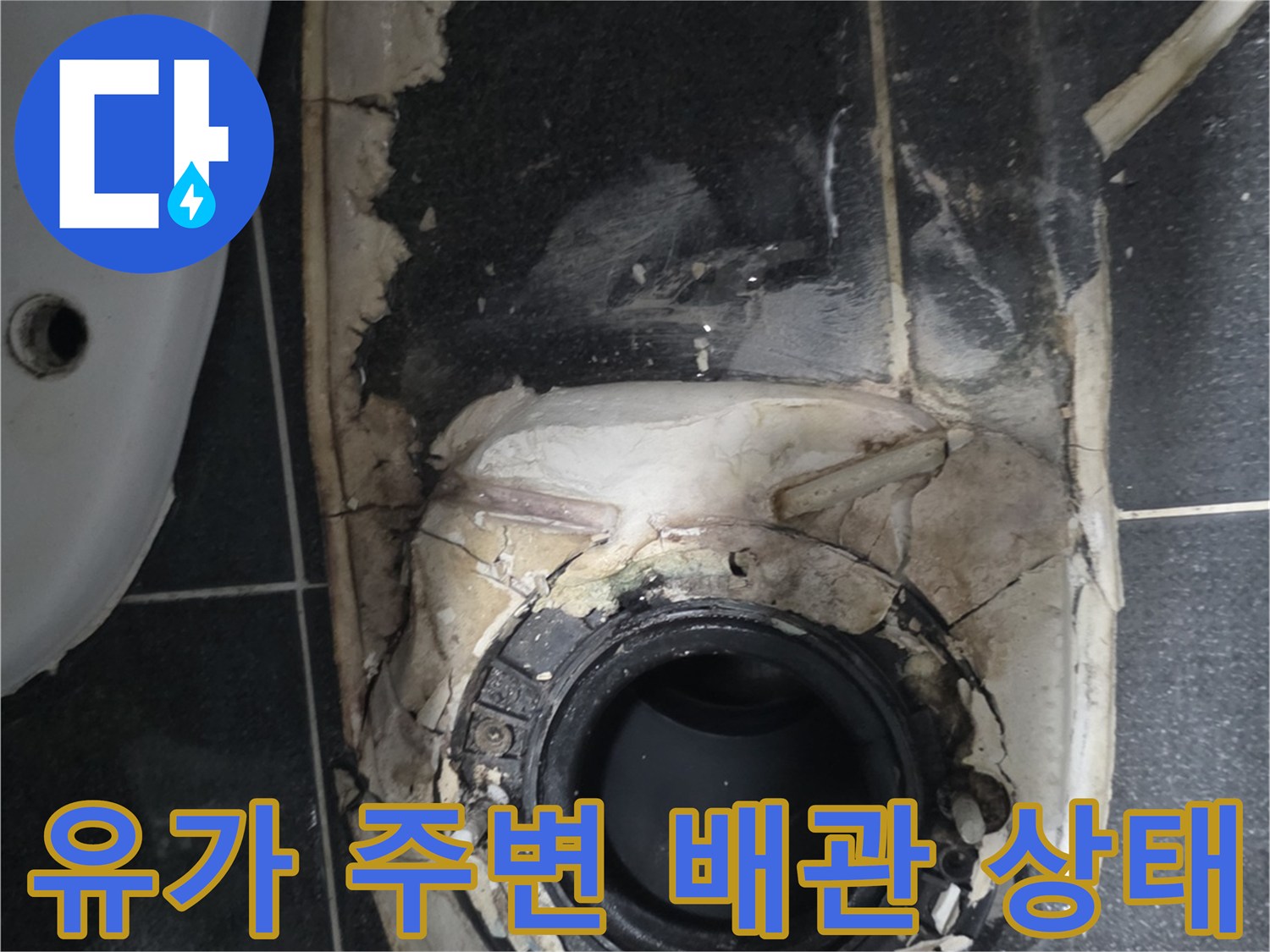 배수구가 제거된-화장실 바닥의 노출된 배관과 틈새 사진