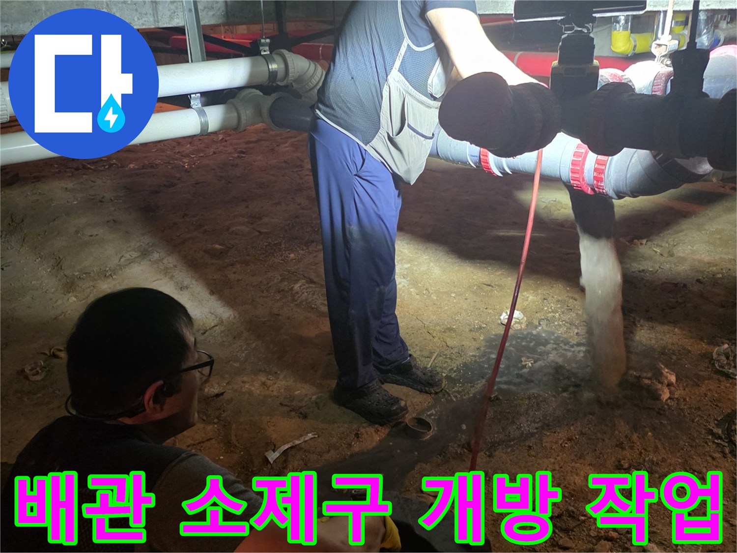 배관 막힘 해결을 위해-소제구를 열고 작업을 진행하는 모습