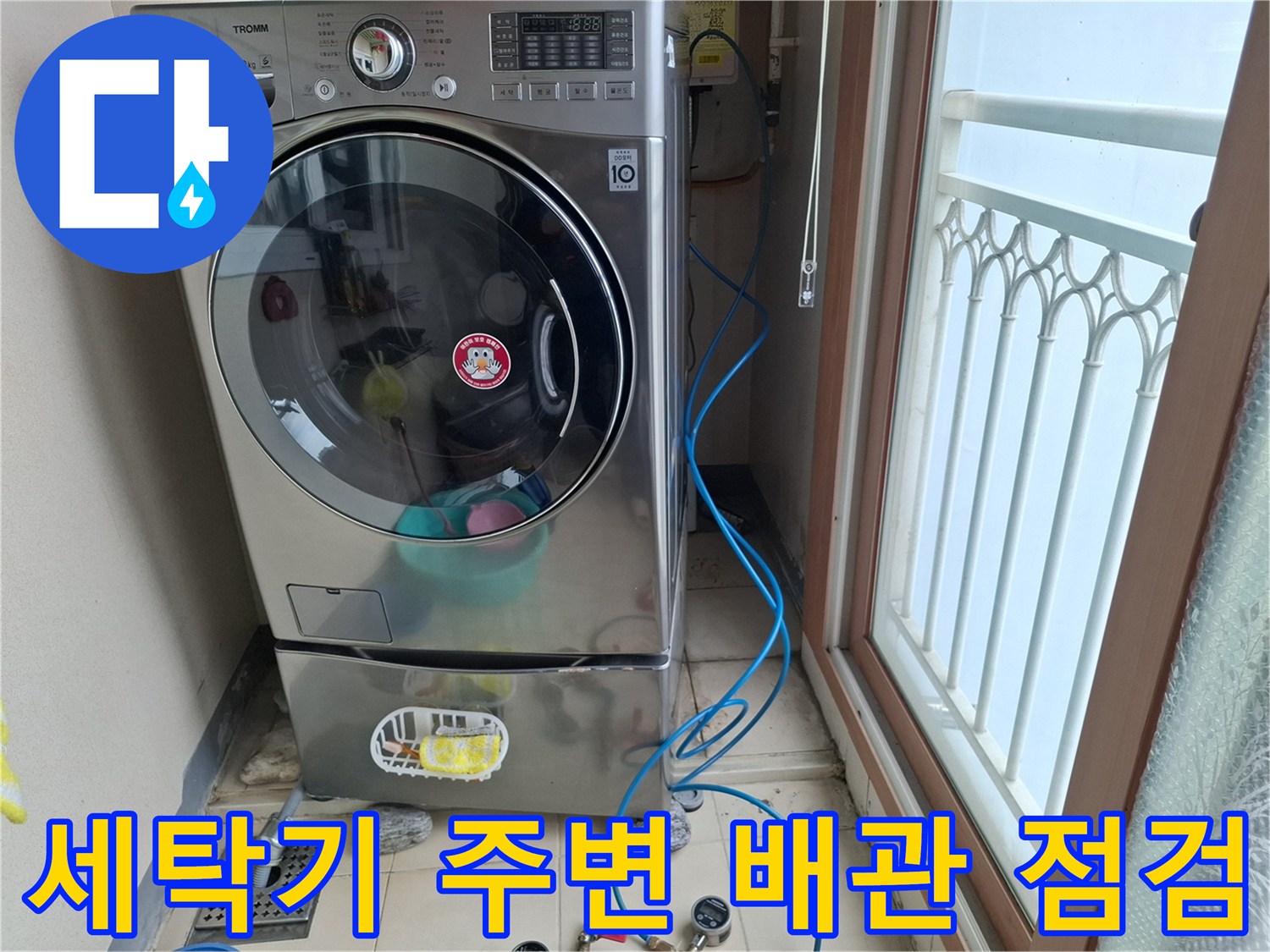 세탁기 옆 베란다 바닥에 설치된 파란색 공압 테스트용 호스 모습